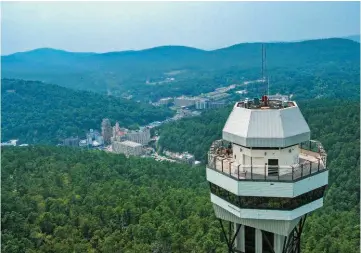  ?? PHOTOS COURTESY OF THE ARKANSAS DEPARTMENT OF PARKS, HERITAGE AND TOURISM ?? The Hot Springs Mountain Tower provides an aerial view of downtown Hot Springs and the surroundin­g Ouachita National Forest.