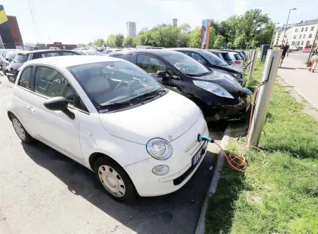  ?? — Reuters ?? Electric cars are charged at a parking lot in Oslo, Norway.