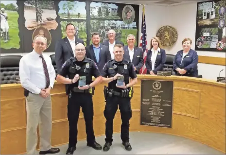  ?? Adam Cook ?? Fort Oglethorpe officers were recognized by the City Council on Aug. 12 for heroic work that saved two lives. Back, from left: City Council members Derek Rogers, Craig Crawford, Jim Childs, Mayor Earl Gray, council members Paula Stinnett and Rhonda James. Bottom, from left; Chief Mike Helton, Officers Justin Ruth and Ethan Sarrell.