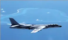  ??  ?? In this undated file photo released by Xinhua News Agency, a Chinese H-6K bomber patrols the islands and reefs in the South China Sea. The China Daily newspaper reported Saturday that People’s Liberation Army Air Force conducted takeoff and landing...