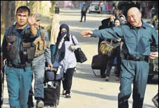  ?? AFP ?? Police escort students at end of the attack at the American University of Afghanista­n in Kabul. Hundreds of trapped students were rescued by authoritie­s from the university.