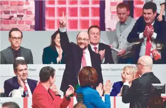  ?? — AFP ?? Newly elected SPD president and candidate for Chancellor of Germany’s social democratic SPD party Martin Schulz flashes the V-sign after his election as party members applaud at the Congress of Germany’s Social Democratic Party on Sunday in Berlin.