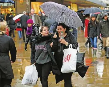  ??  ?? Braving the weather Bad weather fails to deter shoppers on London’s Oxford Street. However, online shopping fared much better this year and is set to be a deciding factor in retailers’ fortunes next season.