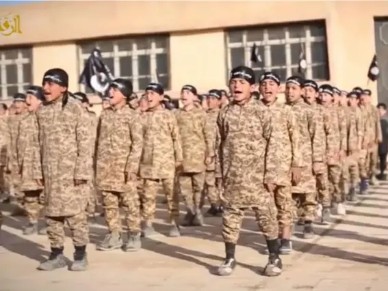  ??  ?? Isis child soldiers in a 2015 propaganda video from Syria (Isis)