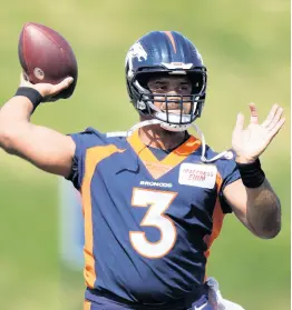  ?? AP ?? Denver Broncos quarterbac­k Russell Wilson takes part in drills at the NFL football team’s voluntary minicamp Wednesday, April 27, 2022, at the team’s headquarte­rs in Englewood, Colorado.