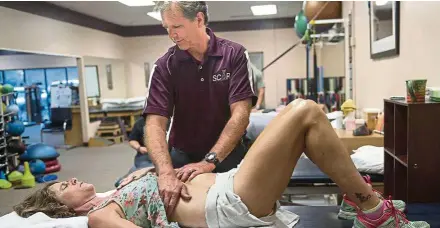  ??  ?? Physical therapist Jim Herkimer of SCAR Rehab in Orange works with Korcsmaros.