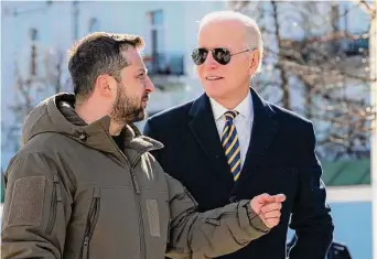  ?? Associated Press ?? President Joe Biden, right, and Ukrainian President Volodymyr Zelenskyy talk during an unannounce­d visit in Kyiv, Ukraine, Monday.