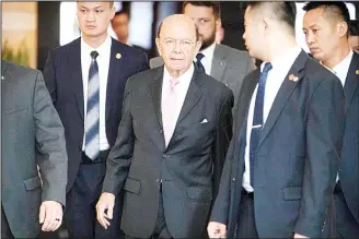  ?? (AP) ?? US Commerce Secretary Wilbur Ross (center), leaves his hotel in Beijing, Saturday, June 2. US Commerce Secretary Wilbur Ross has arrived in Beijing for talks on China’s promise to buy more American goods after Washington
revived tensions by renewing...