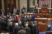  ?? ASSOCIATED PRESS ?? Democrats mingle on the House floor late Friday after approving a $1 trillion package of road and other infrastruc­ture projects.