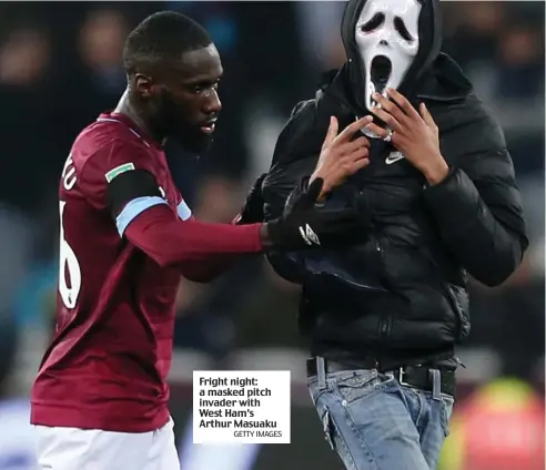  ?? GETTY IMAGES ?? Fright night: a masked pitch invader with West Ham’s Arthur Masuaku