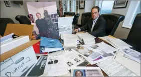  ?? KEN BLAZE – ASSOCIATED PRESS ?? U.S. Marshal Peter J. Elliott poses at the Carl B. Stokes U.S. Courthouse in Cleveland with items related to a 1969bank robbery. After more than 50years, Elliott announced that they had closed the case on one the city’s biggest bank robberies.