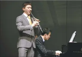  ?? PHOTOS PROVIDED TO CHINA DAILY ?? Clarinetis­t Wang Tao. Wang performs during his tour to Foshan, Guangdong province, in December 2020. He and his wife Liu Xuan.