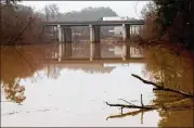  ?? CONTRIBUTE­D BY STEVE SCHAEFER ?? After days of rain, a Chattahooc­hee River overflow area is filled along Riverview Road in Mableton. Metro Atlanta had one of its wettest years.