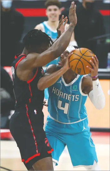  ?? KIM KLEMENT/USA TODAY SPORTS ?? Raptors forward Stanley Johnson (left) pressures Charlotte Hornets guard Devonte' Graham during Toronto's 116-113 win on Saturday night.