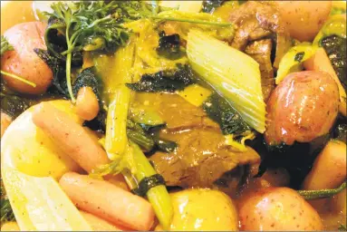  ?? Yong Kim / Knight Ridder Tribune ?? Beef brisket with vegetables and gravy is often served at Passover’s seder dinner.