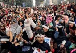  ?? Reuters ?? SHOW OF SUPPORT: Demonstrat­ors have their eyes covered with a patch during a protest to show solidarity with the Jamia Millia Islamia university student who allegedly lost his eye during a demonstrat­ion against new citizenshi­p law, in New Delhi on Sunday. —