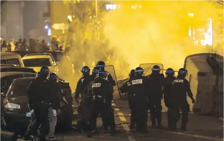  ?? CLAUDE PARIS, THE ASSOCIATED PRESS ?? Police in Marseille, France, take position Saturday in a demonstrat­ion about dilapidate­d residentia­l buildings that collapsed on Nov. 5, killing eight people. Meanwhile, thousands of police were deployed on Paris’ Champs-Elysees avenue to try to contain protests over rising taxes and President Emmanuel Macron’s government.