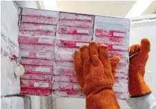  ?? CAROLYN KASTER/AP PHOTO ?? Biologist Jason Plyler, top, prepares to test how immune cells react to possible flu vaccines. Biologist Rebecca, bottom, Gillespie pulls boxes of flu virus from a freezer at the Vaccine Research Center at the National Institutes of Health.