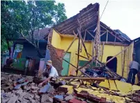  ?? Reuters ?? A man cleans up the wreckage of a house damaged by quake in Tasikmalay­a City, West Java, Indonesia on Saturday. —
