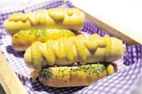  ??  ?? The sea urchin hotdog is a popular item at the Blue Water Cafe.