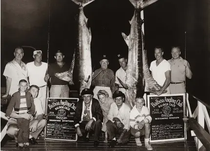 ??  ?? As a child, Bill Shedd (on left) would visit the docks to check out the day’s catch. His father, Milt, (standing, second from left) helped captain 5 Bells to a good day off Southern California.