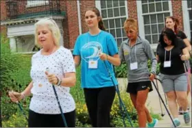  ?? MICHILEA PATTERSON — DIGITAL FIRST MEDIA ?? A group of educators practice their arm movements during a Nordic walking seminar at Pottstown Middle School for the “Healthy Bodies, Healthy Minds Institute.”