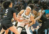  ?? JOHN LOCHER/AP ?? Sky forward Candace Parker, center, battles for the ball with Aces forward Dearica Hamby, left, and guard Chelsea Gray, right, on June 21, 2022, in Las Vegas.