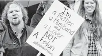  ?? Rick Bowmer / Associated Press ?? Kody Brown, left, from TV’s reality show “Sister Wives,” protests in 2017 at the Capitol in Salt Lake City.