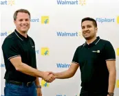  ??  ?? Walmart Inc CEO Doug McMillon with Flipkart CoFounder and CEO Binny Bansal in Bengaluru during the takeover. The US retail behemoth had announced that it was acquiring a 77 per cent stake in India’s largest ecommerce firm for about $ 16 billion (` 1.05...