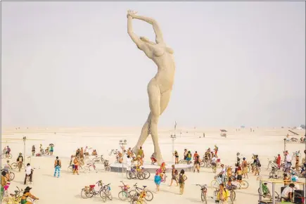  ?? ELEANOR PREGER VIA THE NEW YORK TIMES ?? Marco Cochrane’s monumental sculpture, “Truth is Beauty,” 55 feet tall, is shown during its 2013 debut at Burning Man. The Smithsonia­n American Art Museum is inviting the radical art of the desert into the Renwick Gallery for an exhibition, “No...