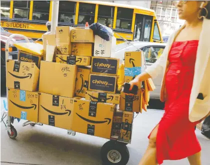  ?? LUCAS JACKSON/REUTERS ?? Analysts say Amazon’s plan to halve delivery times to one day for Prime members will help Amazon win business. The Seattle-based retail monster is trying to beat rivals like Walmart that have marketed two-day shipping with no subscripti­on fees.