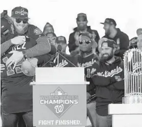  ?? JOSE LUIS MAGANA/AP ?? World Series MVP Stephen Strasburg, in sunglasses at left during the Nationals’ parade, opted out of his contract with the team and will test his worth in free agency.