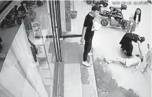  ?? © The New York Times Co. ?? This image from surveillan­ce footage shows Liu Zengyan on the street after jumping from a window to escape an assault by her husband at the time, shown standing on the sidewalk, in August 2019 in Shangqiu, China.
