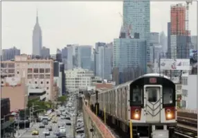  ?? FRANK FRANKLIN II — THE ASSOCIATED PRESS FILE ?? In this file photo, patrons ride the number 7 subway train in the Queens borough of New York. If you’re a transporta­tion buff, New York City is the perfect destinatio­n.