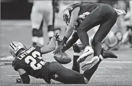  ?? [CURTIS COMPTON/ATLANTA JOURNAL-CONSTITUTI­ON] ?? Saints cornerback Marshon Lattimore, left, intercepts a pass from Falcons quarterbac­k Matt Ryan in the final minute of the second quarter as safety Marcus Williams tumbles past. The play set up a touchdown for New Orleans.