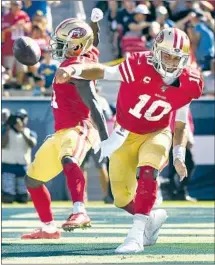  ?? Wally Skalij Los Angeles Times ?? JIMMY GAROPPOLO (10) celebrates with Marquise Goodwin after scoring a touchdown for San Francisco in the third quarter.