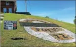  ?? ANDREW CASS — THE NEWS-HERALD ?? Fallen Mentor police officer Mathew Mazany’s badge was painted onto the hillside out of Fairport Harbor’s Marine Museum and Lighthouse. The theme of this year’s Mardi Gras was “Fairport Harbor Honors Our First Responders.”