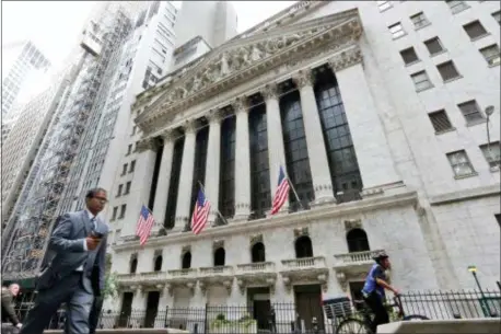  ?? RICHARD DREW — THE ASSOCIATED PRESS FILE ?? FILE- In this file photo, people pass the New York Stock Exchange. The U.S. stock market opens at 9:30 a.m. EDT on Friday.