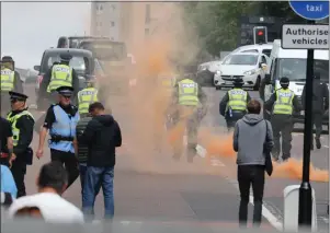  ?? Pictures: Stewart Attwood ?? Police at the demo in George Square, below, while left, ‘smoke bombs’ can be seen in the street