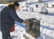  ?? LISA RATHKE AP ?? Deb Walker, of Chester, Vt., visits the grave of her daughter, who died in March 2021 of a drug overdose.
