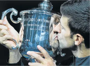  ?? Picture: TIMOTHY A CLARY/AFP ?? BACK ON TOP: Serbia’s Novak Djokovic kisses the trophy after winning against Argentina’s Juan Martin del Potro during their men’s singles finals match at the 2018 US Open