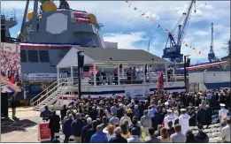  ?? PHOTOS BY DAVID SHARP — THE ASSOCIATED PRESS ?? A crowd attends the christenin­g ceremony for the future USS Basilone, in the background, on Saturday at Bath Iron Works in Bath, Maine.