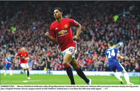  ??  ?? SHINING STAR . . . Marcus Rashford celebrates after firing Manchester United into the lead over Chelsea after just seven minutes of play during yesterday’s English Premier Soccer League match at Old Trafford. United won 2-0 to blow the title race wide...
