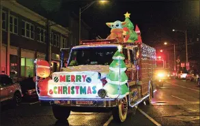  ?? Christian Abraham / Hearst Connecticu­t Media ?? Danbury Fire Department trucks make their way through downtown Danbury in a parade to celebrate the start of the Christmas holiday after a tree lighting at the Danbury Public Library on Dec. 4. The coronaviru­s pandemic forced the event to be scaled down and shown virtually online.