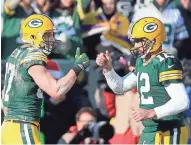  ?? RICK WOOD / MILWAUKEE JOURNAL SENTINEL ?? Wide receiver Jordy Nelson (left) and quarterbac­k Aaron Rodgers celebrate a touchdown by Nelson on Saturday.