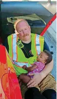  ?? [PHOTO PROVIDED BY FIREFIGHTE­R ENGINEER KYLE VRADENBURG­H] ?? Chattanoog­a firefighte­r Chris Blazek calmed this baby after a car crash.