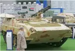  ?? Photos by Ryan Lim ?? Visitors view the Khalifa 2 122mm self propelled Howitzer D-30 and Khatim-4 armoured missle launcher displayed at the Sudan Pavilion on the 3rd day of Idex. —