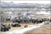  ?? MIKE MCCLEARY/THE BISMARCK TRIBUNE ?? Law enforcemen­t enters the Oceti Sakowin camp to begin arresting Dakota Access Pipeline protesters and cleaning out the camp near Cannon Ball, N.D., on Thursday.