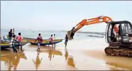  ?? PTI ?? An earthmover is used to pull fishing boats ashore in view of the Cylone Jawad, in Visakhapat­nam, on Friday