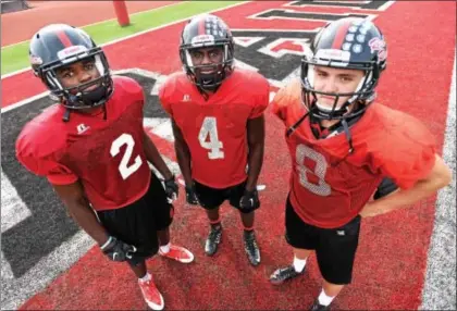  ??  ?? PETE BANNAN - DIGITAL FIRST MEDIA Coatesvill­e’s triple threat of standouts, from left, wide receiver Avery Young, junior Aaron Young and sophomore quarterbac­k Rick Ortega.